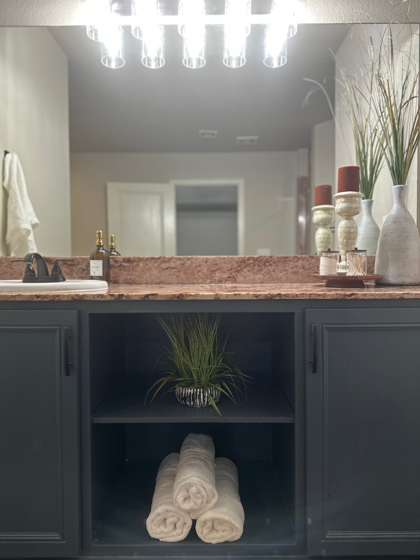 Tidy Owasso bathroom vanity with rolled towels after a Scrubbr clean